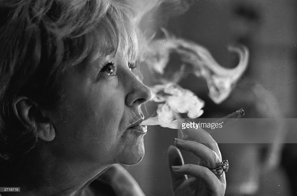 actress-beryl-reid-learning-to-smoke-a-cigar-for-her-role-in-the-play-picture-id2716719